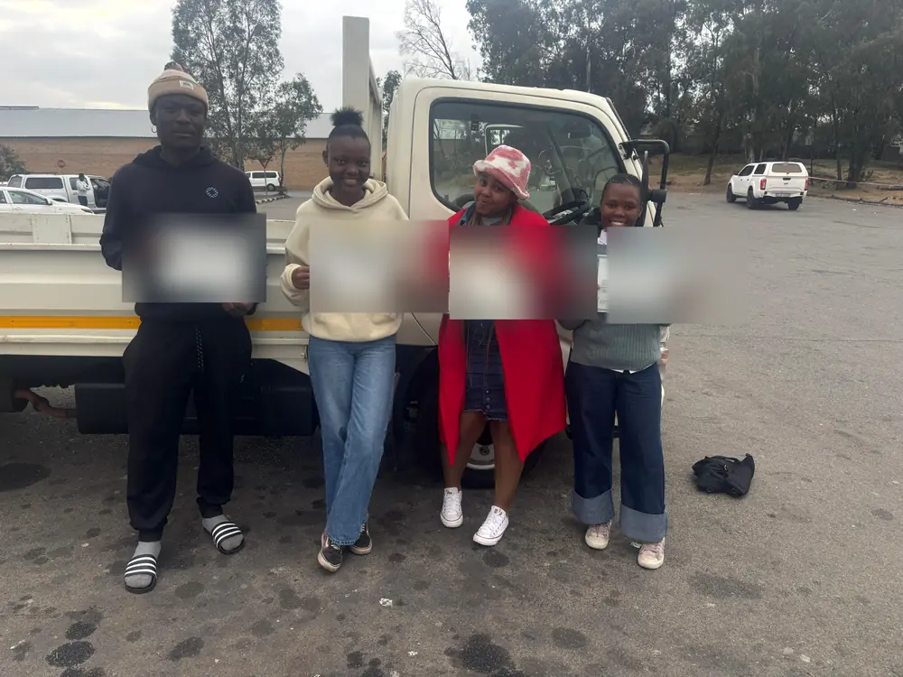 Four learners celebrating after passing