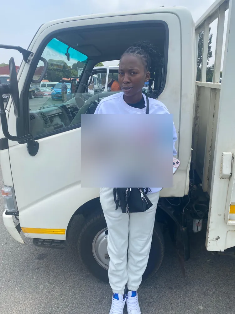 Learner celebrating after passing, beside the training truck
